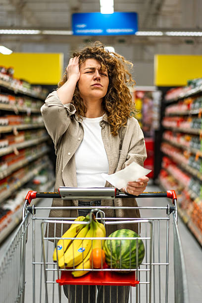 istock Woman feeling concerned about grocery prices on the bill 2208161275