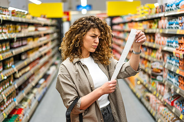 istock Woman feeling concerned about grocery prices on the bill 2208161294