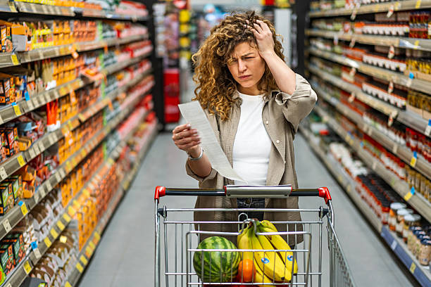 istock Woman feeling concerned about grocery prices on the bill 2208161312