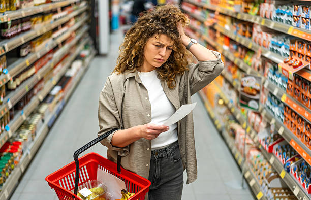 istock Woman feeling concerned about grocery prices on the bill 2208161322
