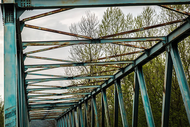 Steel trusses framing an empty road on a rural bridge