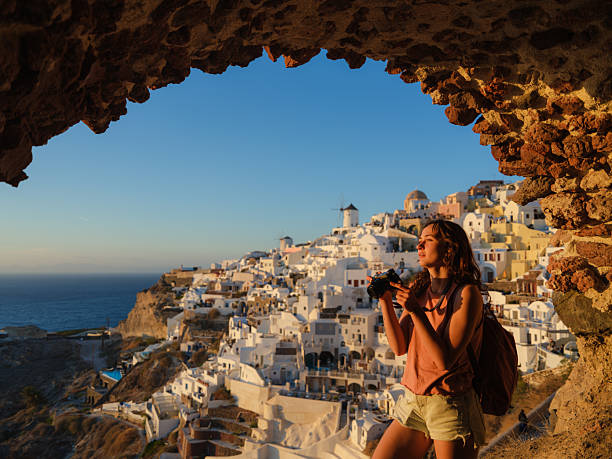 istock Woman with camera  looking with awe in Oia, Santorini 2208164179