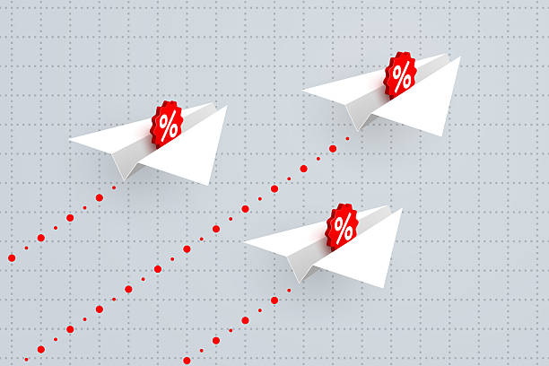 istock White paper airplanes with percent signs over business graph 2208164543