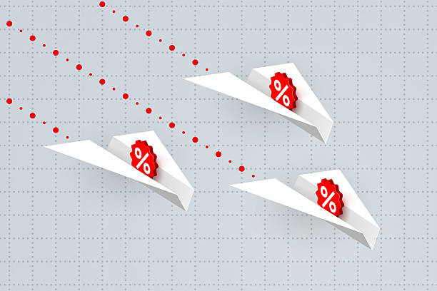 istock White paper airplanes with percent signs over business graph 2208164583