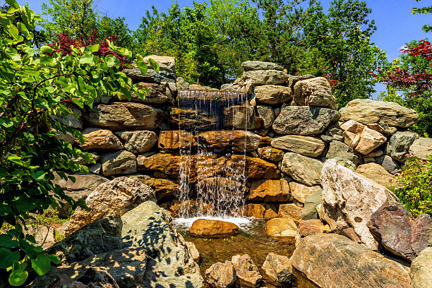 istock Beautiful decorative waterfall in a public park 2208164809
