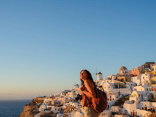 istock Woman looking with awe in Oia, Santorini 2208165027