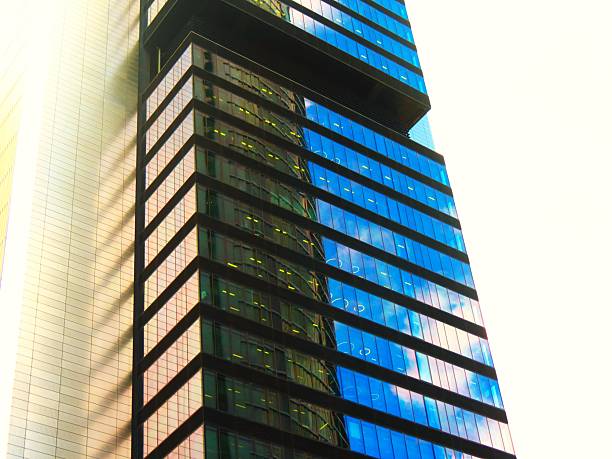 Skyscraper - glass building .Corporate Buildings. Skyscraper located in Madrid city, Spain. Interesting reflections in the glass windows of a building.Paseo de la castellana, main avenue of the city of Madrid from north to south, Spain
