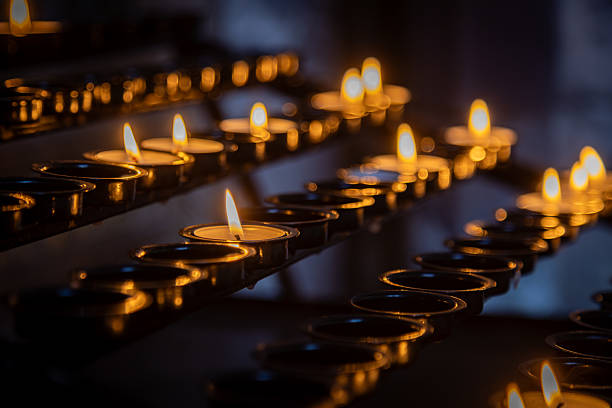 istock Candles lit in a church for prayer and remembrance 2208166699