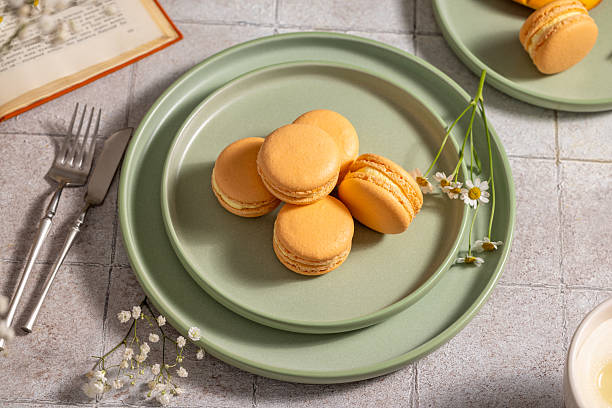 Delicious macarons resting on a green plate, creating a delightful culinary scene