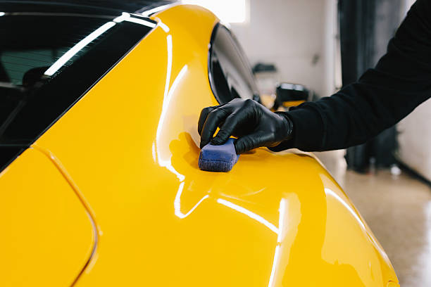 istock Process of applying a ceramic coating to the sports car surface for protection during detailing session at the service. Detailing ceramic polishing at the car service. 2208167594