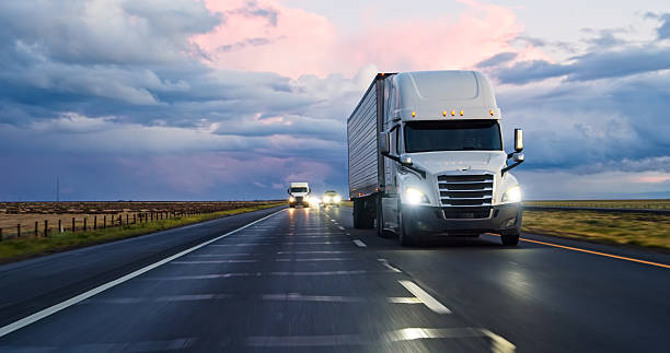 istock Car POV of Semi-Trucks Driving Interstate 5 Under Beautiful Clouds 2208170614