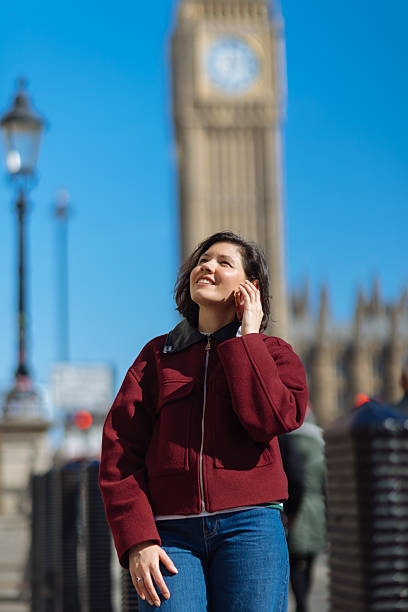 istock Woman using phone at Westminster in London 2208172519