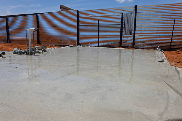 istock slab fresh poured concrete on the construction site, corrugated sheet fence 2208172619