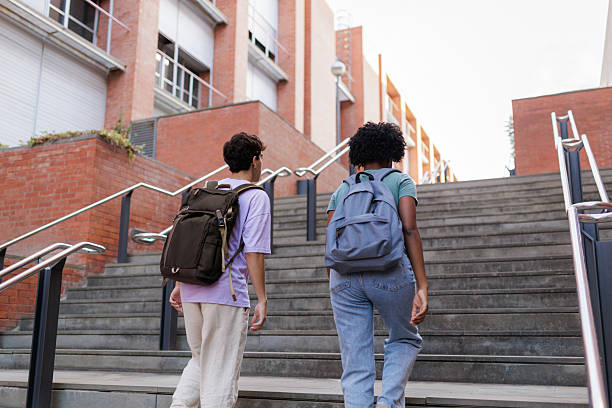 istock Students walking up stairs at university campus 2208177300