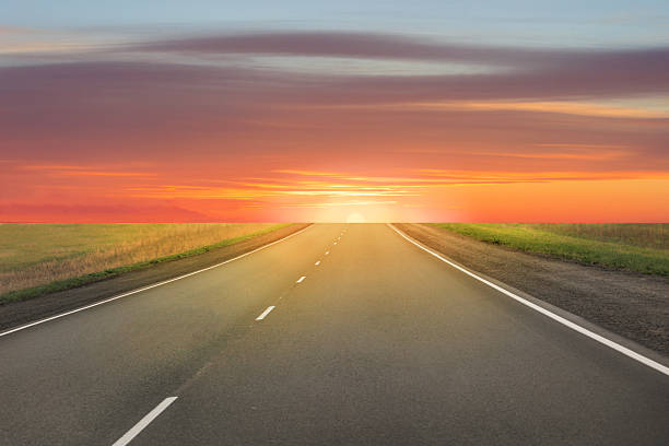 istock Beautiful sunset over a country road 2208177475