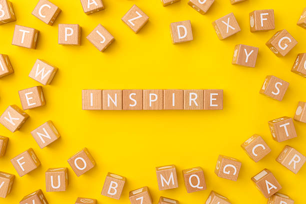 istock Block Words with Inspire on a Yellow Background 2208177533