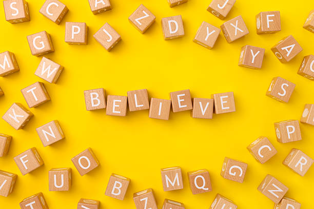 istock Block Words with Believe on a Yellow Background 2208177539