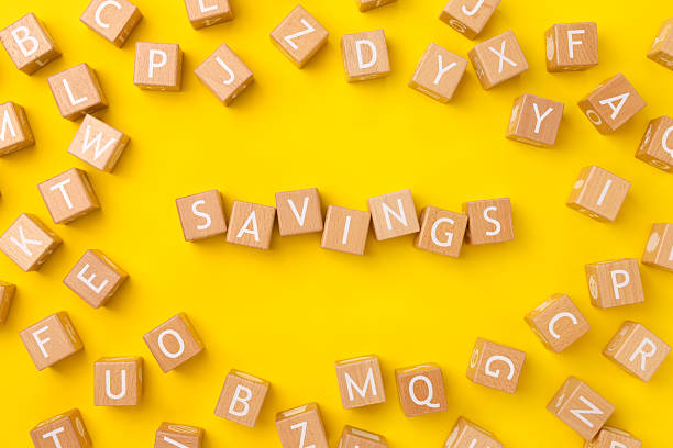 istock Block Words with Savings on a Yellow Background 2208177548