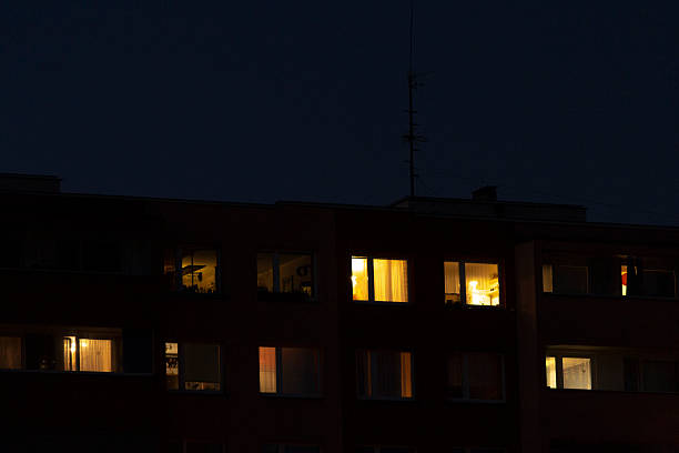 istock A tall building with numerous windows shines bright at night time 2208180511