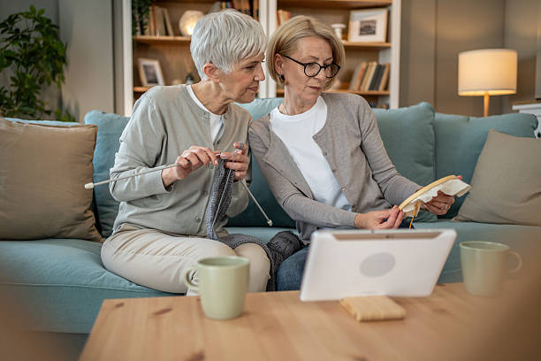 istock Two senior women learning knitting and embroidery online 2208181322