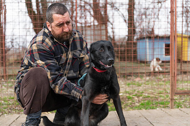 istock Volunteer form dog shelter with his dog 2208181619