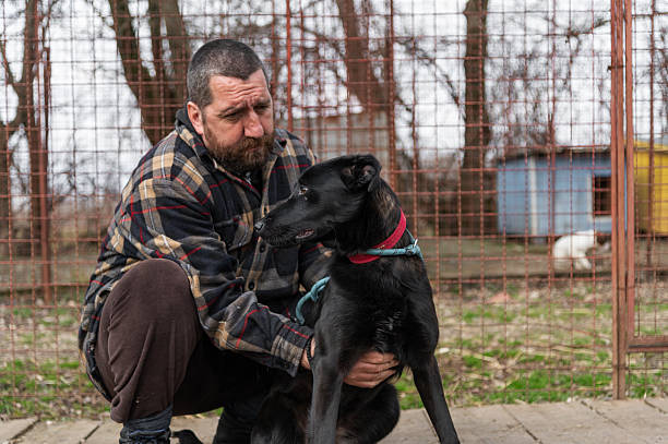 istock Volunteer form dog shelter with his dog 2208181666