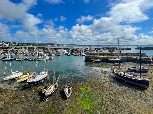 istock Sailboats Anchored in Blue Bay with Cape 2208182028