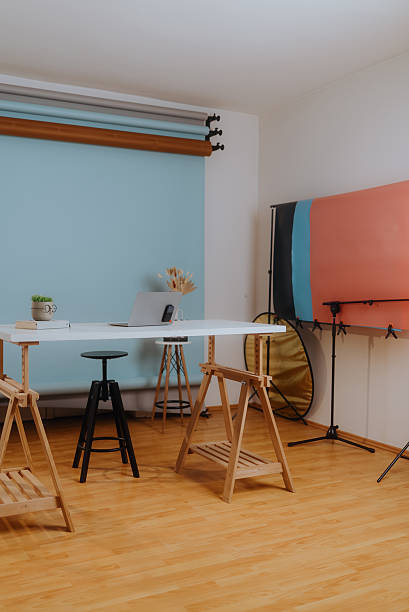 istock Modern photo studio with laptop and backdrops ready for shooting 2208182819