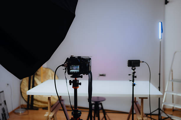 istock Professional photo shooting setup with camera, lights, and tripod in a modern studio 2208182852