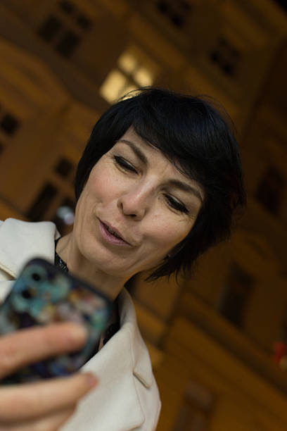 istock A woman is happily taking a selfie using her cell phone device 2208183426