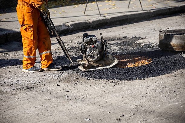 istock Worker operates a concrete compactor on a street under repair during daylight for effective asphalt application 2208184152