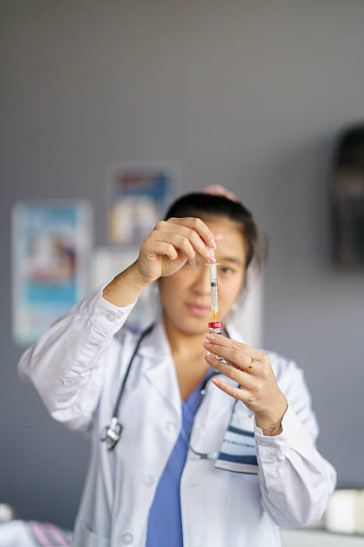 istock Doctor Preparing Syringe with Medication in a Clinical Environment 2208184978