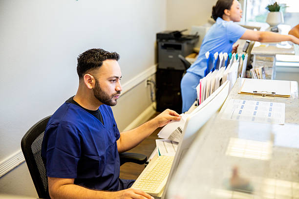 istock Nurses working at the front reception area of a medical office 2208188379