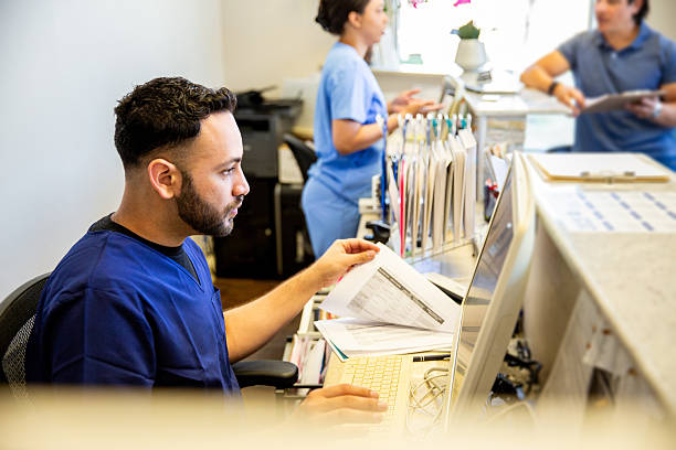 istock Nurses working at the front reception area of a medical office 2208188400