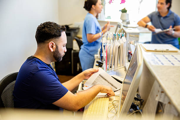 istock Nurses working at the front reception area of a medical office 2208188504