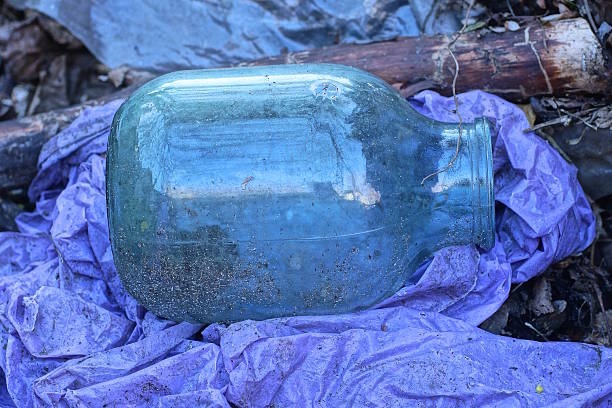 View on several empty transparent washed jars, drying on hot air of a radiator 