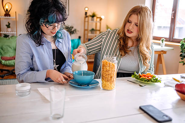 Teenage girls having breakfast together at home