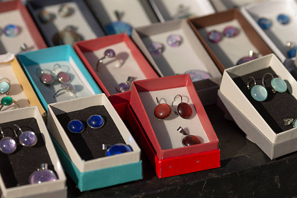 istock Colorful earrings displayed in boxes on a black background, visually appealing 2208193025