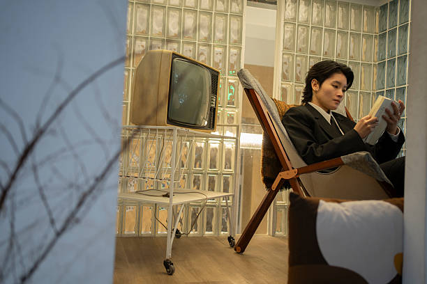 Short haired woman sitting on the sofa reading a book