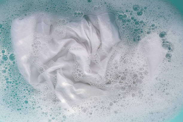 istock White cloth soaked in powder detergent water dissolution, washing cloth. Laundry concept 2208194960