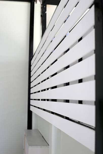 istock The white slatted fence provides privacy between houses while allowing some airflow and light 2208196148