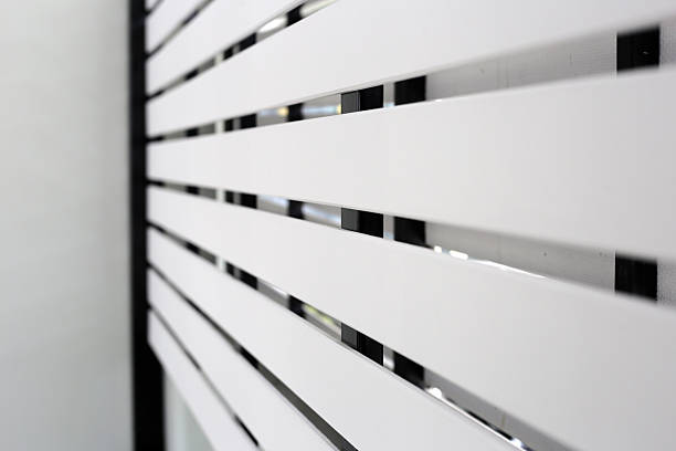 istock The white slatted fence provides privacy between houses while allowing some airflow and light 2208196266