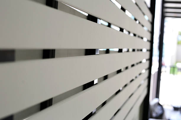 istock The white slatted fence provides privacy between houses while allowing some airflow and light 2208196387