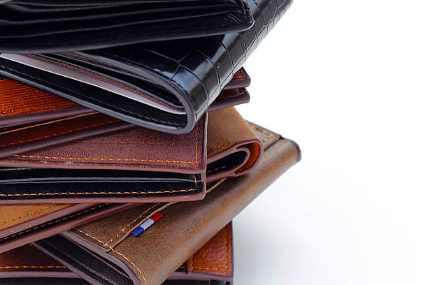 istock Stack of black and brown wallets on white background. 2208197555