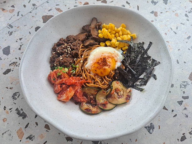 istock Fried Dry Ramen Noodle With Minced Beef, Onsen Egg, Shitake Mushroom, Corn, Nori, Kimchi, Pickled Cucumber And Spring Onion. Food Menu. 2208200340