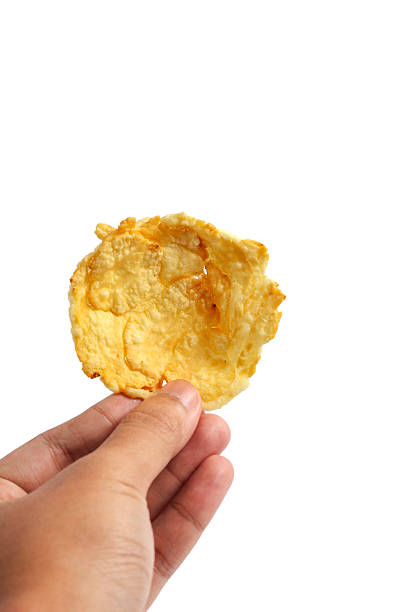 istock man hand holding Snack emping melinjo isolated on nipple background 2208201208