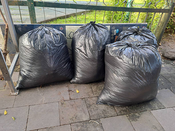 istock Plastic Garbage Bags and Trash Can on Curb 2208203027