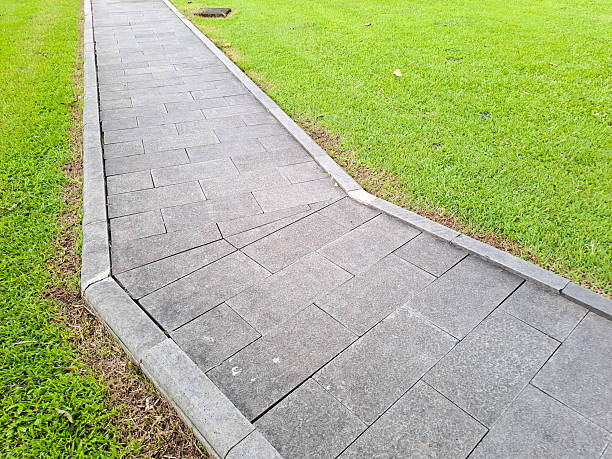 istock Park pedestrian walkway against green grass 2208203104