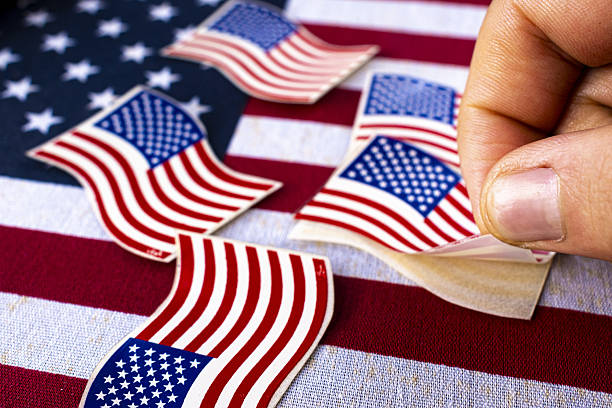 istock Hand taking American flag-themed stickers. 2208203314