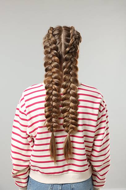 istock Woman with braided hair on grey background, back view 2208206106